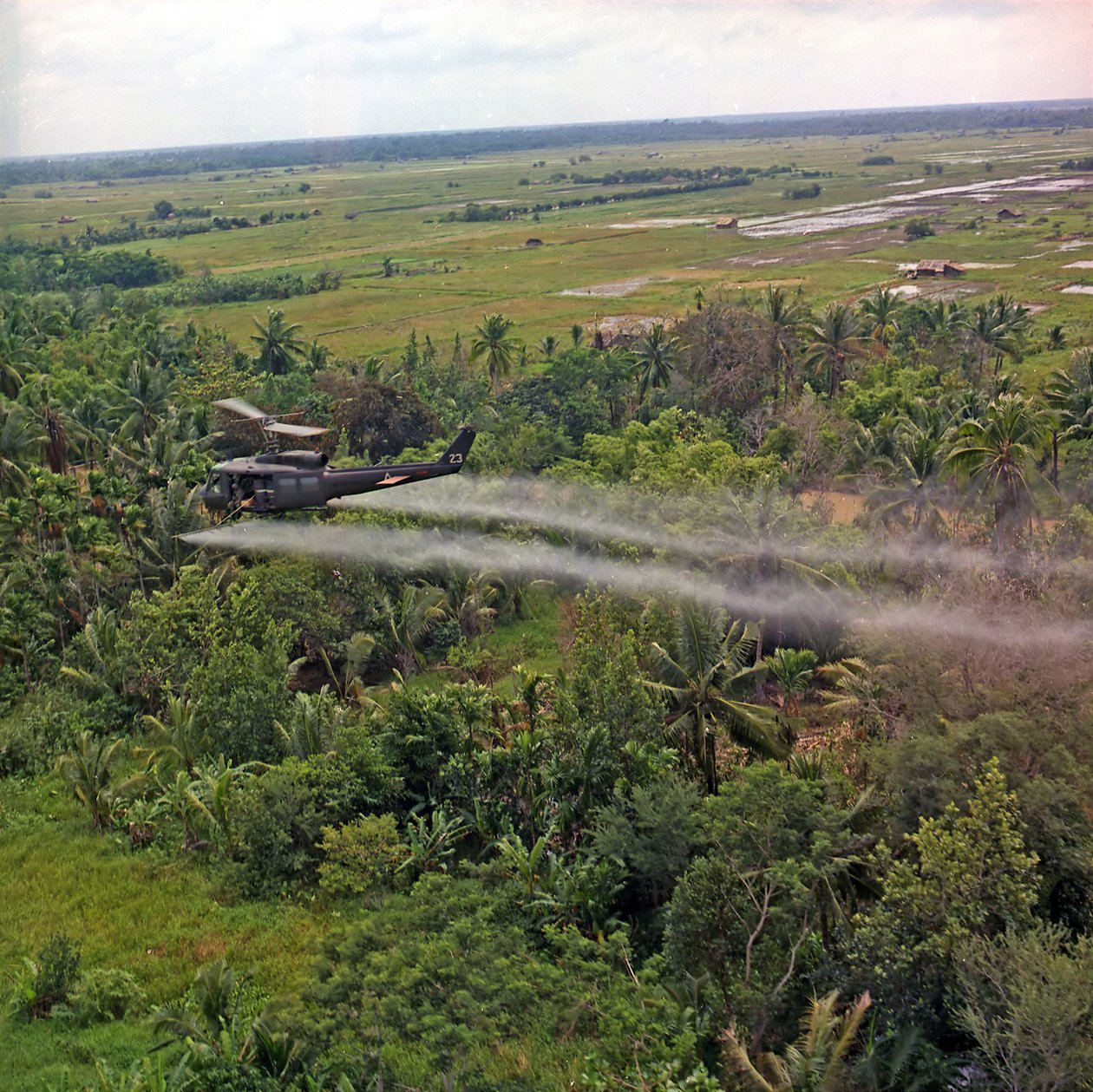 A 336. légitársaság UH-1D helikoptere lombtalanító szert permetez a Mekong-delta sűrű dzsungelében, 1969. július 26-án. alkotó: American Photographer