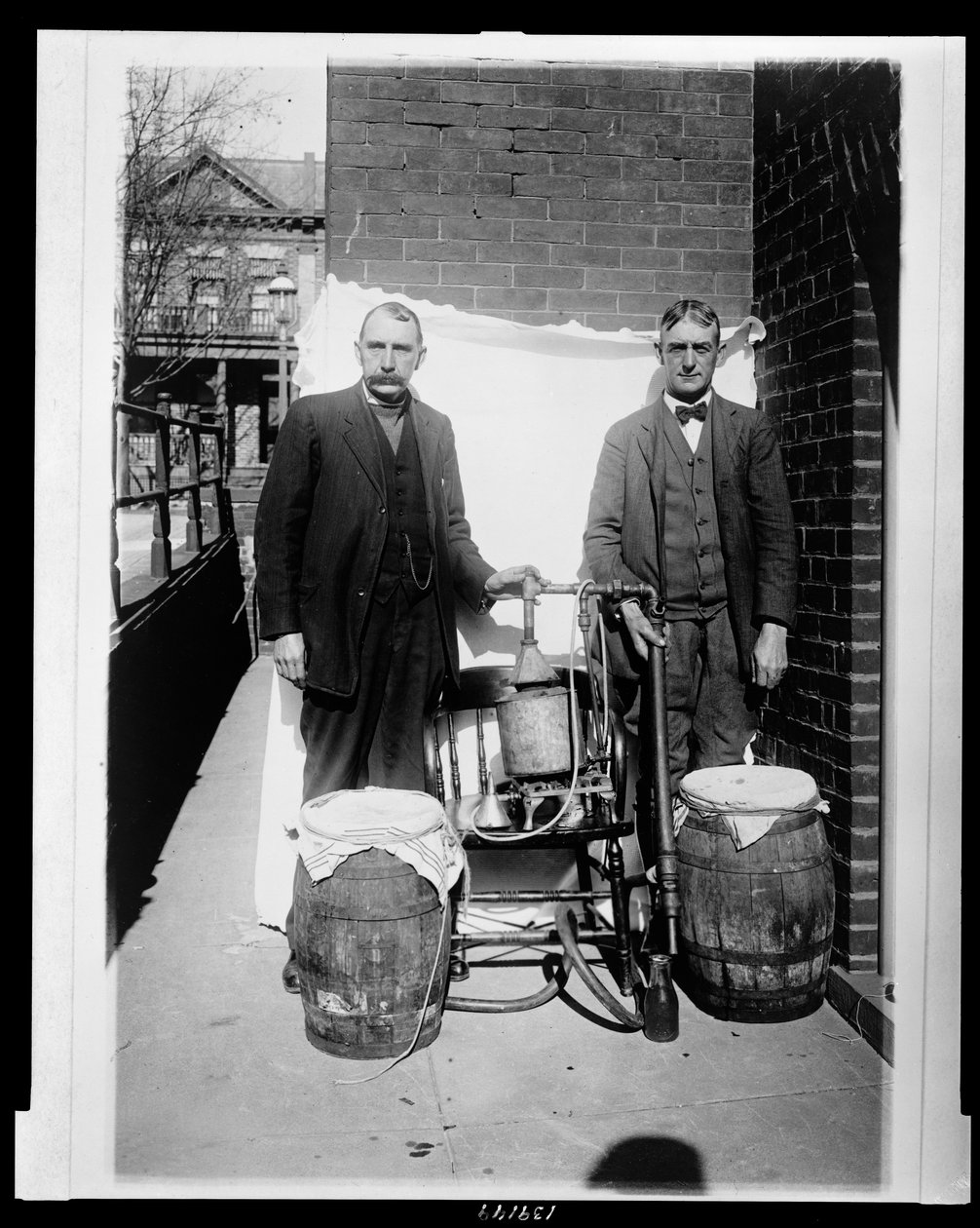 Két férfi pózol egy whisky-lepárlóval alkotó: American Photographer