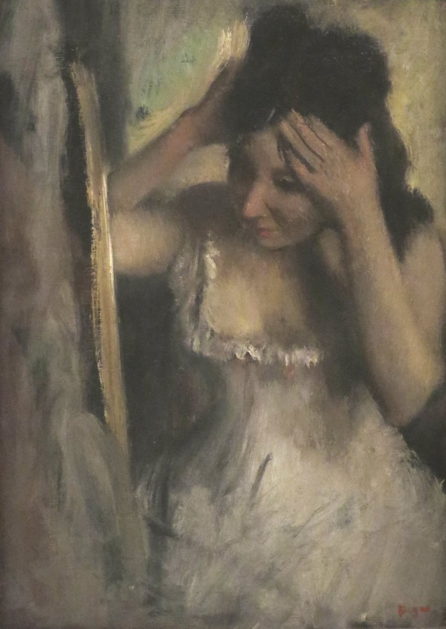 Nő fésülködik a haja előtt a tükör előtt alkotó: Edgar Degas