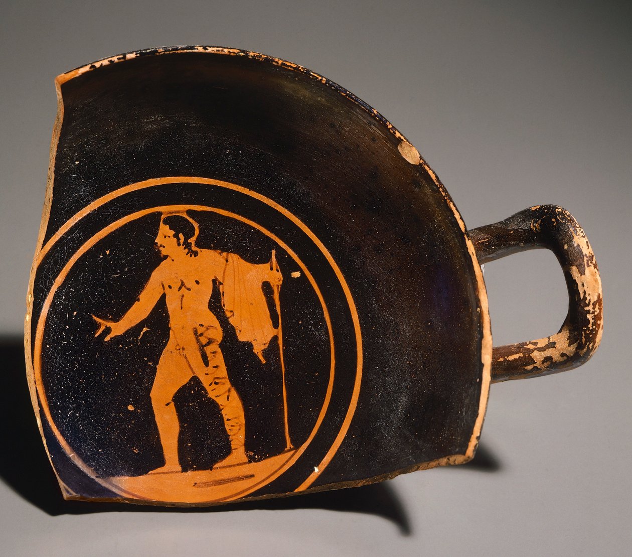Pteriu Paves Kylix, egy fiatalembert ábrázoló töredék és felirat. Vörös alakos kerámia, Grotti 3. sírjából (Toszkána). Etruszk civilizáció, Kr. e. 4. század. alkotó: Etruscan