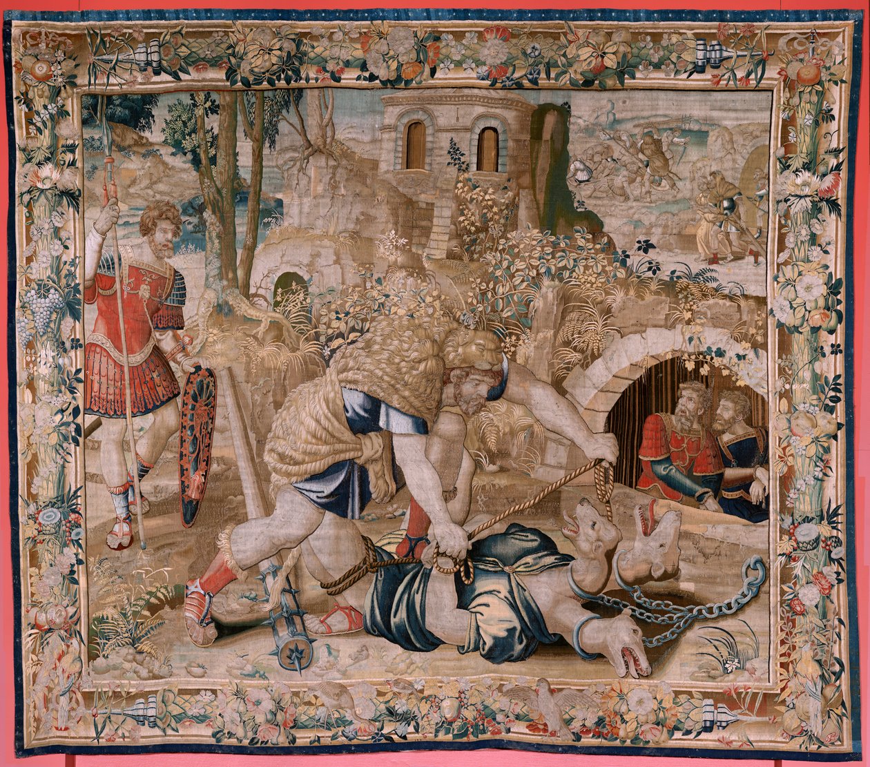Flamand kárpit. Herkules munkássága sorozat. Herkules elfogja Cerberust (Hércules captura a Cancerbero). Hatodik kárpit a fennmaradt sorozatban. Modell Ismeretlen. Gyártás Willem Dermoyen, Brüsszel. Ca1528. Szövet Selyem és gyapjú. Mérete 345 x 390 cm. Loc alkotó: Flemish School