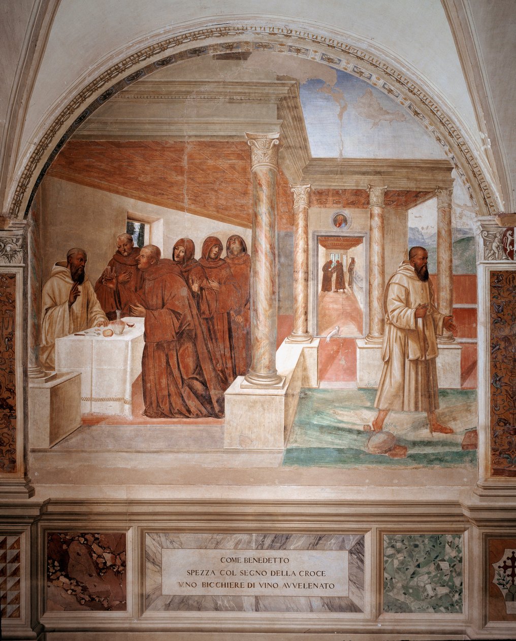Benedek megtör egy pohár mérgezett bort, ezzel megalkotva Antonio Bazzi dit il Sodoma (1477 - 1549) keresztfreskójának jelét, amely Nursie-i Szent Benedek (480 - 567), a Bencés Rend 1503-as alapítója életét meséli el - 1508-as apátság alkotó: Giovanni Antonio Bazzi Sodoma
