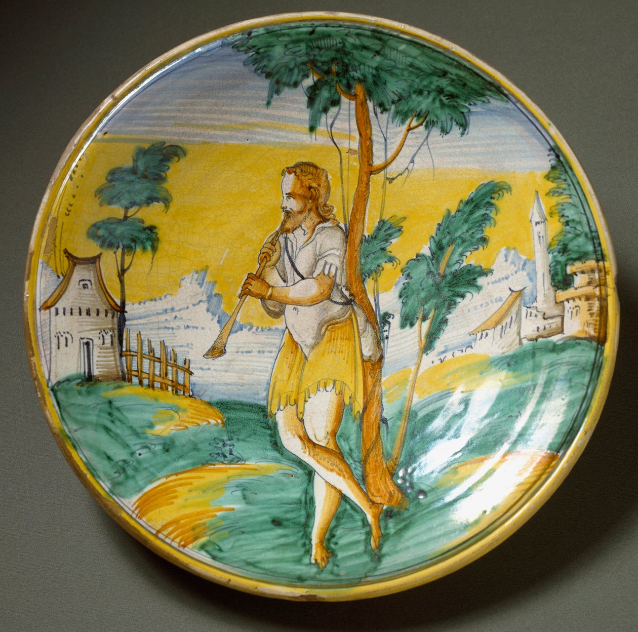 Furulyás egy tájban. Az olaszországi Viterbóban gyártott kerámia lemez. 16. század vége Firenze, Museo Nazionale del Bargello alkotó: Italian School