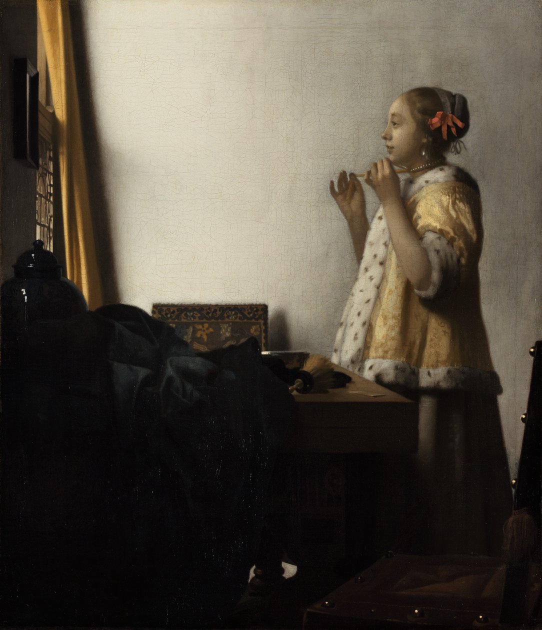 Fiatal hölgy egy gyöngy nyaklánccal alkotó: Johannes Vermeer