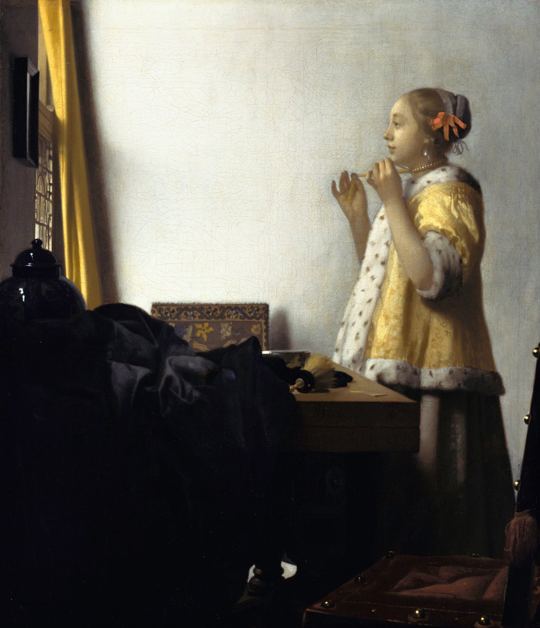 Fiatal nő gyöngy nyaklánccal alkotó: Johannes Vermeer