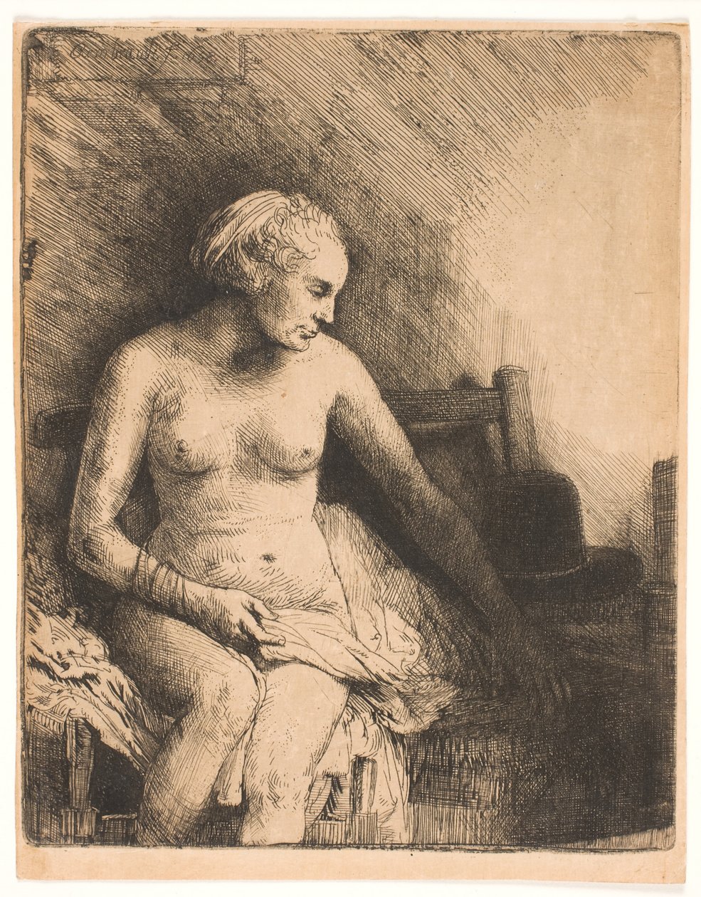 Nő a fürdőben, kalappal mellette alkotó: Rembrandt van Rijn