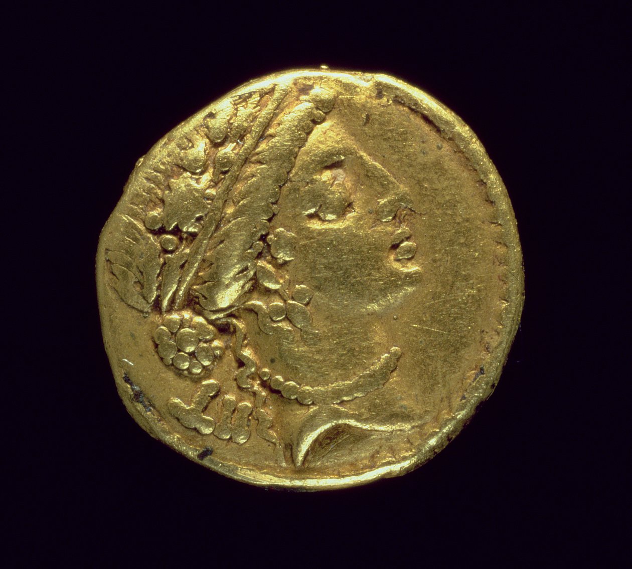 Julius Caesar (Kr. e. 110-44) által vert Aureus (előlap), amely egy női fej jobb oldalán tölgykoszorút és diadémet (arany) ábrázol. alkotó: Roman