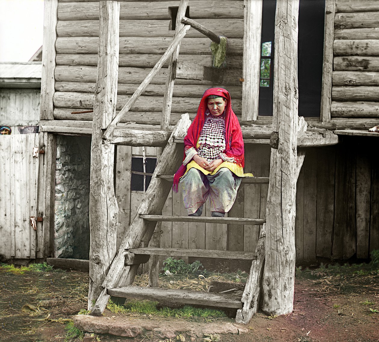 Baskír nő népviseletben ül faházának lépcsőjén, Urál hegység, Orosz Birodalom, 1910 alkotó: Sergey Prokudin Gorsky