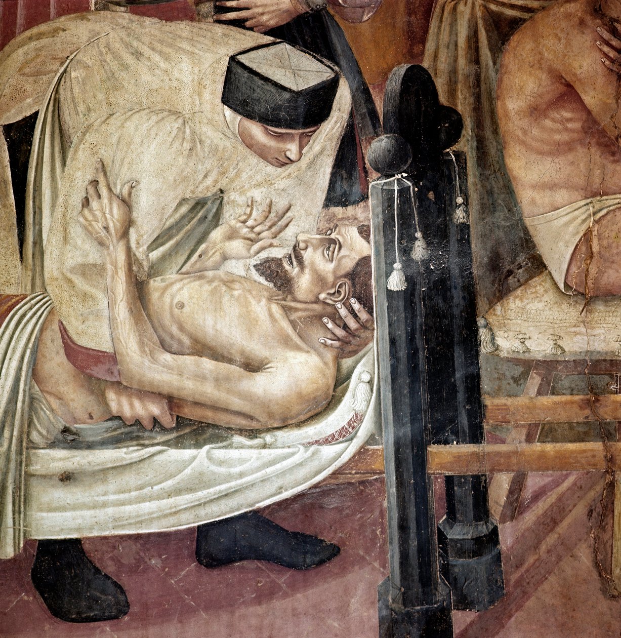 Beteg ellátása kórházban, nővér segíti a hordágyon fekvő sérültet”” Részlet. Taddeo di Bartolo (1363-1422) freskója, 14. századi Siena, Spedale di Santa Maria della Scala alkotó: Taddeo di Bartolo