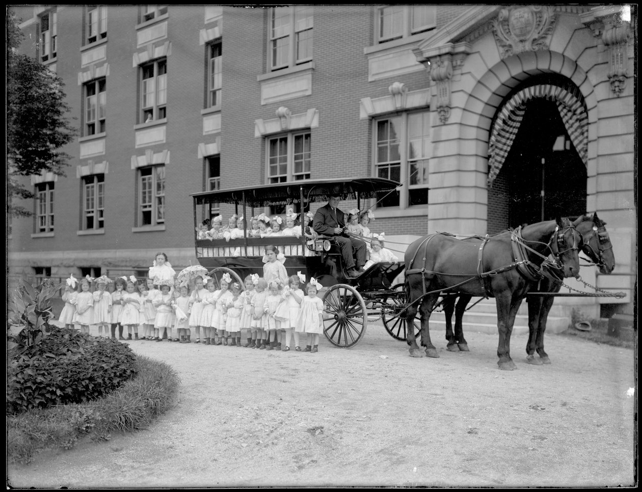 Kislányok pózolnak egy lovas kocsiban és előtte, egy ismeretlen épület előtt, valószínűleg a római katolikus árvamenhely, Kingsbridge, Bronx, 1910 körül alkotó: William Davis Hassler
