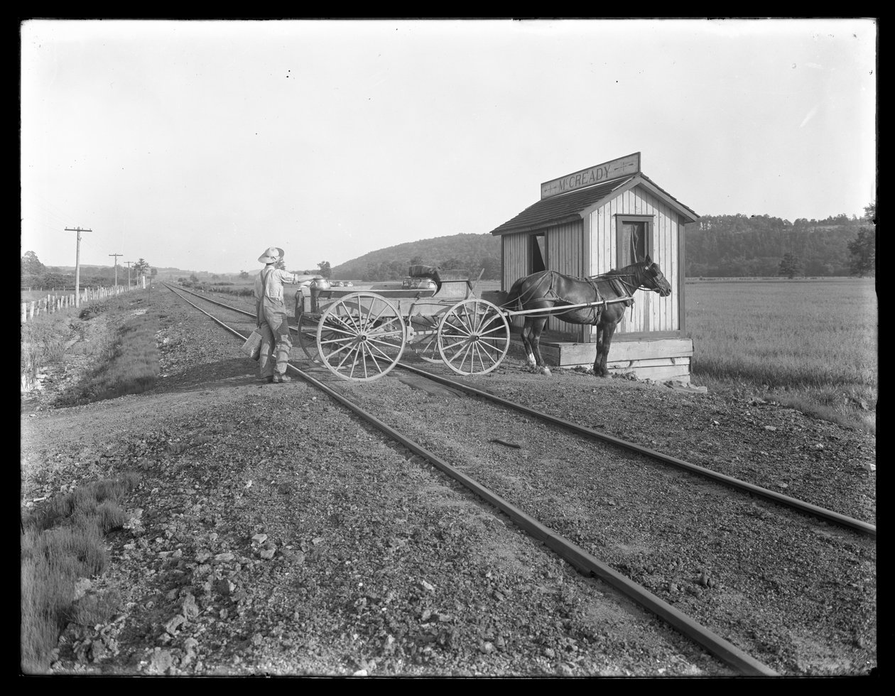 Ismeretlen férfi tejet rakod a McCready farmon kívül a vasúti síneken parkoló lovas kocsira, Pennsylvania, 1913 körül. alkotó: William Davis Hassler