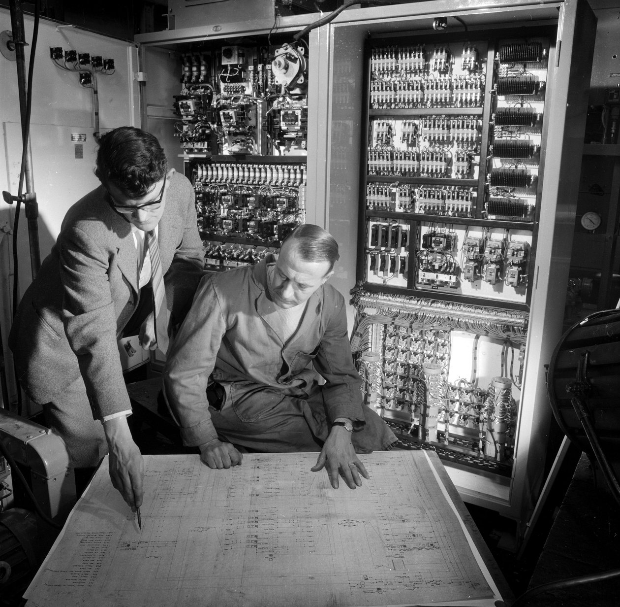 A mérnökök az általuk épített elektronikus vezérlőpanel előtt vitatják meg a terveket alkotó: Frederick (attr. to) Barnard