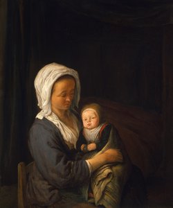 Nő, aki egy gyermeket tart az ölében