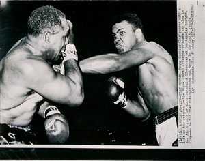 A fiatal Cassius Clay balbal gólt szerez a veterán Archie Moore ellen a Los Angeles-i küzdelem első fordulójában. alkotó: American Photographer