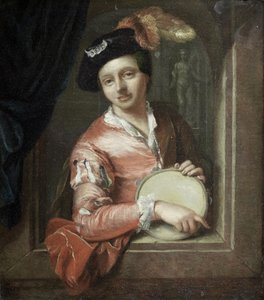 A young boy holding a tambourine