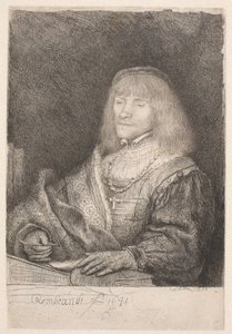 Egy férfi az íróasztalnál, keresztet és láncot visel alkotó: Rembrandt van Rijn