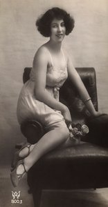 Egy fiatal nő pózol alsószoknyában, egy fotelben ülve. alkotó: Unknown photographer