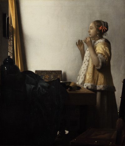 Fiatal hölgy egy gyöngy nyaklánccal alkotó: Johannes Vermeer