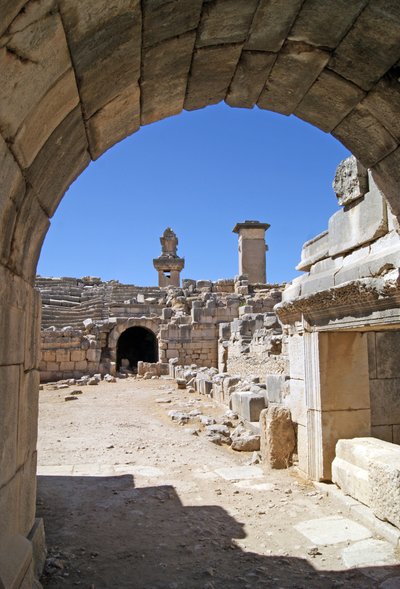 Kilátás a Xanthos színház boltíves bejáratán keresztül a zenekari gödörbe, az oszlop és a hárpia sírja látható, Xanthos, Törökország (fotó) alkotó: Roman