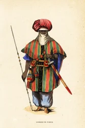 A nigeri Agadez nemes tuareg harcosa tagelmustban (turbán és fátyol), taktkat (ing) és akarbey (nadrág)