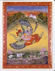 Hinduizmus: Garuda madár ábrázolása, amint Visnut, egy nagy hindu istenséget, és feleségét, Lakhmit viszi