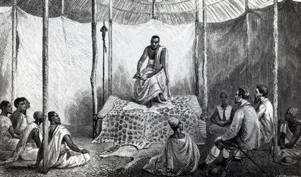 Kamrasi első leckéje a Bibliában, illusztrációja John Hanning Speke „A Journal of the Discovery of the Nílus” című könyvéből, amelyet 1864-ben adtak ki