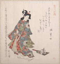 Lány és egy hagoita (japán tollaslabda-ütő és tollaslabda)