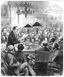 Heinrich Schliemann előadást tart Londonban, 1877