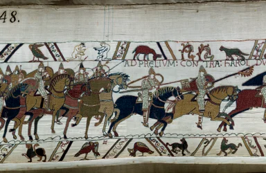 Anglia meghódítása Hódító Vilmos normann herceg (1027-1087) által 1066-ban: hadserege II. Harold hada felé nyomul a Hastings A bal alsó sarokban két meztelen férfi Részlet a Bayeux-i kárpitról vagy Mathilde királynő hímzéséről
