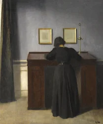 Ida íróasztalnál áll, 1900